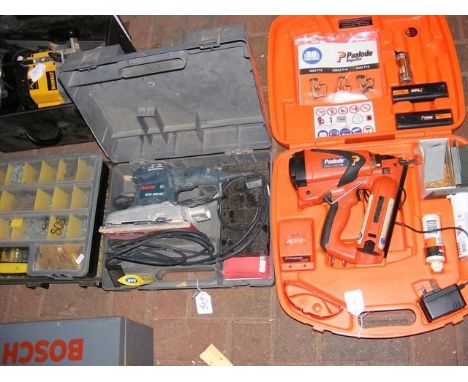 A boxed nail gun together with sander and screws