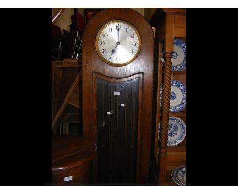 A 1930's oak cased three train chiming Grandfather clock