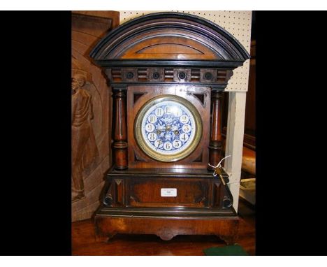 An antique striking mantel clock - 54cms high