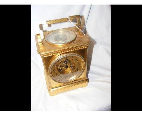 A large antique gilt carriage clock with visible escapement and circular thermometer and compass to the top - 23cms high