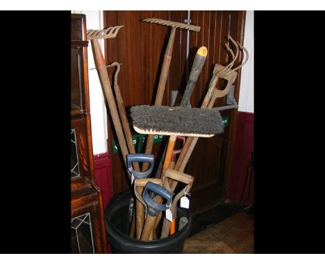 various garden tools contained in a dustbin