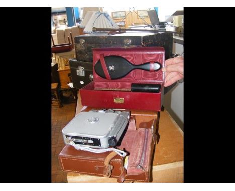Vintage suitcases together with cine-camera etc