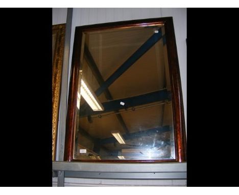 A bevelled wall mirror in painted surround
