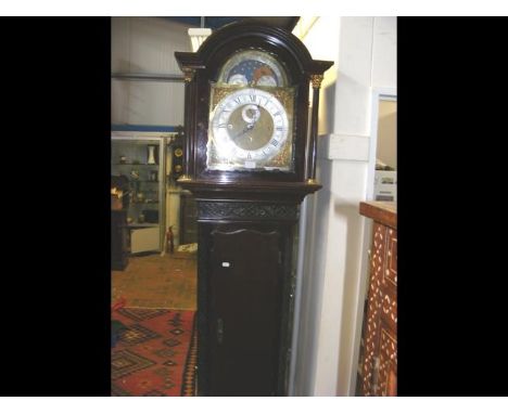 A mahogany cased eight day Grandfather clock, having moon phase arch dial and eight bell and four bell mechanism - 225cms hig