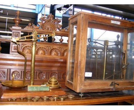 A set of laboratory scales, together with scales and weights