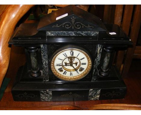 An antique slate and marble mantel clock with visible escapement - 34cms high