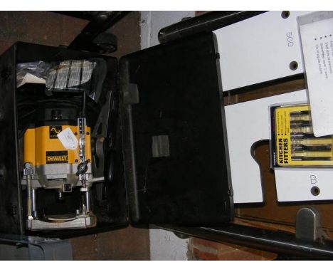 A Dewalt boxed router together with kitchen fitters tools
