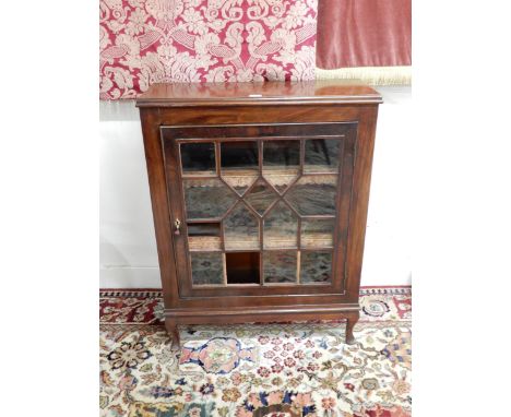 A Victorian mahogany astragal glazed pier cabinet with single door concealing two shelves with embossed leather shelf edging 