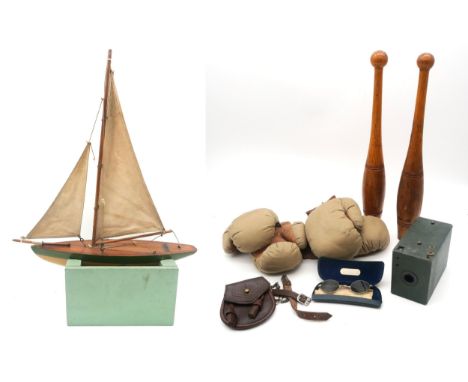 A pond yacht by Glasgow Model Dockyard, Argyll Arcade, two pairs of canvas and leather boxing gloves, two Indian clubs, a chi