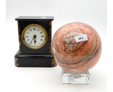 A hardstone globe on stand and a slate mantle clock Condition Report:Available upon request