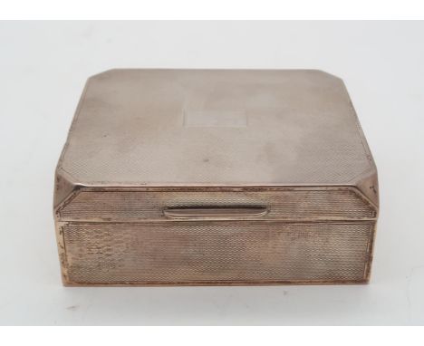 A George V silver cigarette box, by E N Speak, Birmingham 1931, of canted rectangular form, the body with engine turned decor