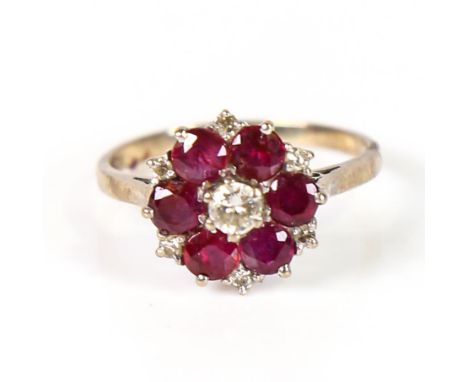 A late 20th century 18ct gold ruby and diamond cluster ring, central diamond approx 0.15ct, setting height 12.8mm, size P, 3.