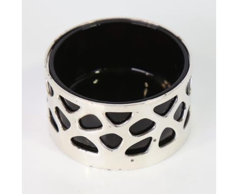 An Elizabeth II modernist silver salt cellar, cylindrical form with openwork geometric design, with amethyst glass liner, by 