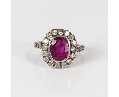 A Vintage ruby and diamond cluster ring, unmarked gold and silver settings, with oval mixed-cut ruby and round brilliant-cut 