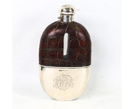 A large Victorian silver and crocodile mounted clear glass hip flask, with screw-lock cap and removable beaker, by Andrew Bar