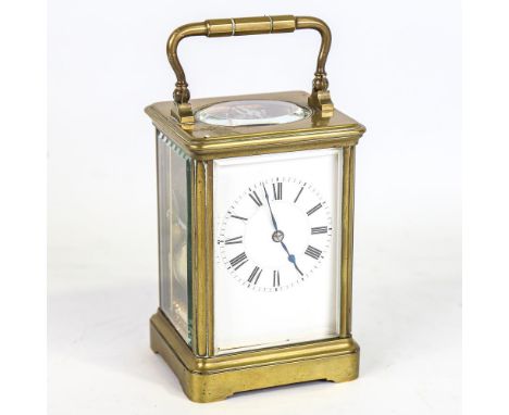 An Antique French brass carriage clock, white enamel dial with Roman numerals and blued steel hands with movement striking on
