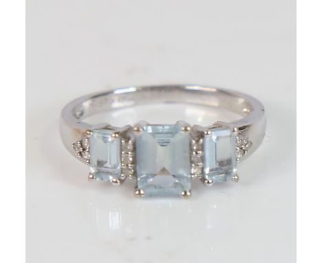 A modern 9ct white gold aquamarine and diamond dress ring, set with emerald-cut aqua and eight-cut diamonds, setting height 7