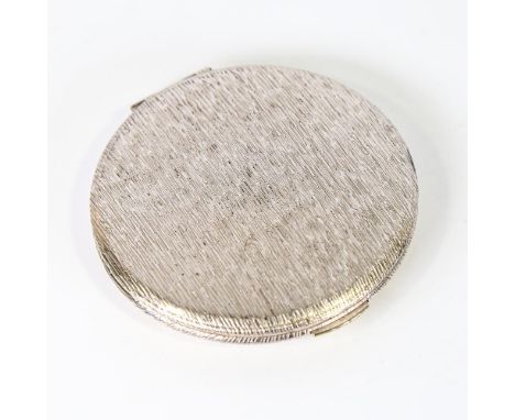 An Elizabeth II circular silver compact, allover textured decoration, by Kigu, hallmarks London 1966, diameter 8.5cm, 3.2oz g