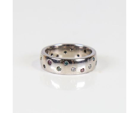 A modern vari-hue diamond wedding band ring, unmarked white metal settings set with fancy coloured diamonds such as blue pink