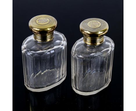ASPREY - a pair of George V silver-mounted glass dressing table perfume bottles, silver-gilt engine turned decoration, by Asp