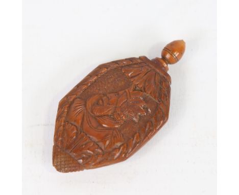 An 18th century coquilla nut snuff bottle, relief carved portrait of a King wearing a crown, length 6cm 