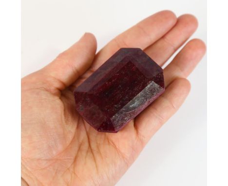 646.00ct rectangular step-cut ruby, 53.00mm x 35.00mm x 25.00mm, indications of colour enhancement, 129.57g, with GLI Gemston