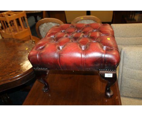 AN OXBLOOD FOOT STOOL