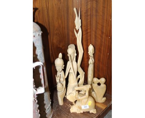 A SELECTION OF CARVED LIGHT WOOD ORNAMENTS