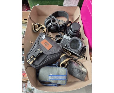 A box of cameras including Pentax P30 and Yashica Electro AX and a pair of headphones