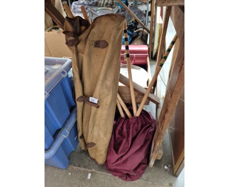 A bag of croquet mallets and a bag of cricket stumps 