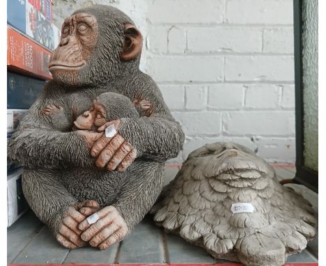 Two stoneware garden ornaments; chimpanzees and a green man wall plaque. 