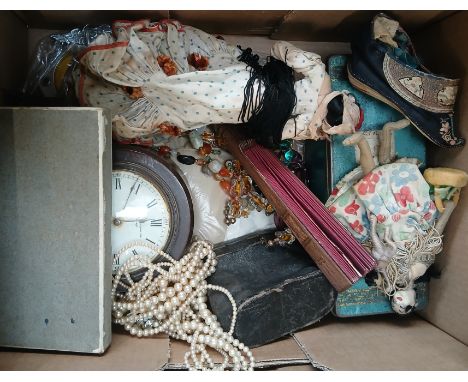 A box of assorted collectables including dolls, a Chinese embroidered slipper, costume jewellery, clock etc.