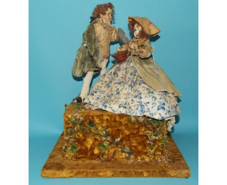 An automaton, of a couple, on a platform base, 36 cm wide