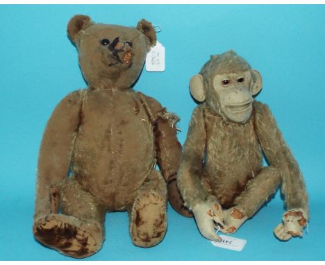 A Steiff plush jointed teddy bear, with button to ear, 41 cm high, and a similar Jacko style monkey, 27 cm high (both a.f.) (