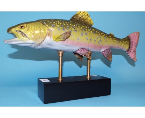 A ceramic fish, on a plinth, 26 cm high