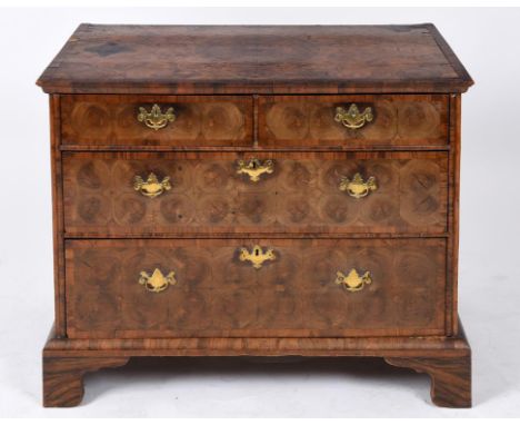 A chest, crossbanded, with boxwood stringing and oyster cut veneer, having two short and two graduated long drawers, on brack
