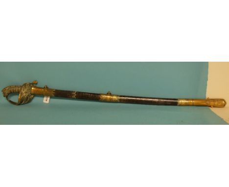 A Victorian Royal Naval officers sword, with wire bound handle, fishskin grip, lion head pommel and brass mounted scabbard