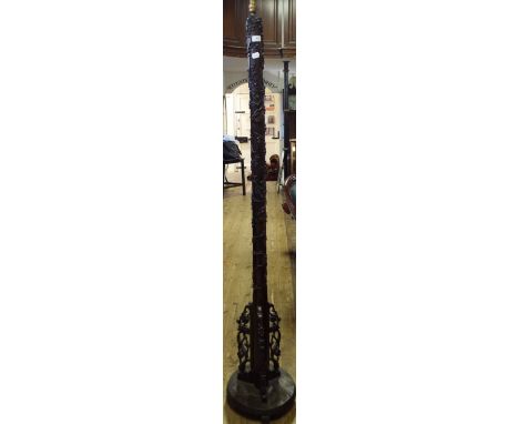 A Chinese hardwood standard lamp, carved prunus