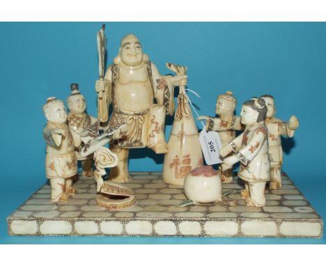 A carved bone group, of children playing, 31 cm wide