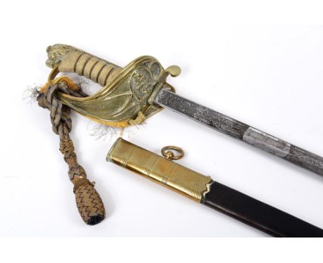 A Queen Elizabeth II Royal Navy officers sword, engraved J N HUMPHRY-BAKER, with a wire bound fish skin grip and lion head po