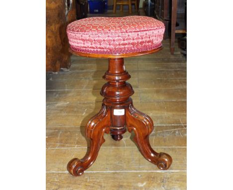 A Victorian upholstered piano stool
