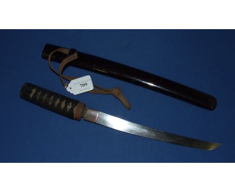 A Japanese tanto, with a cord bound fishskin grip, and black lacquered scabbard (incomplete), 45 cm long (overall)