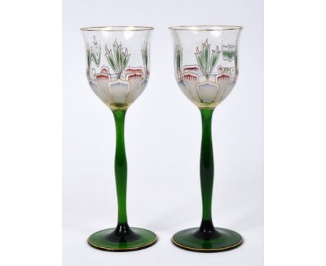 A pair of Theresienthal style hock glasses, with enamel and gilt decoration, on green glass stems, 21.5 cm high  See illustra