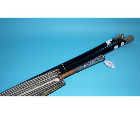 A parasol, with a silver coloured metal mount, a silver mounted walking cane, and another similar (3) Condition report Report