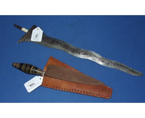 A Malayan kris blade, and a horn mounted knife, in a leather scabbard (2) Condition report Report

No, the tape on the handle