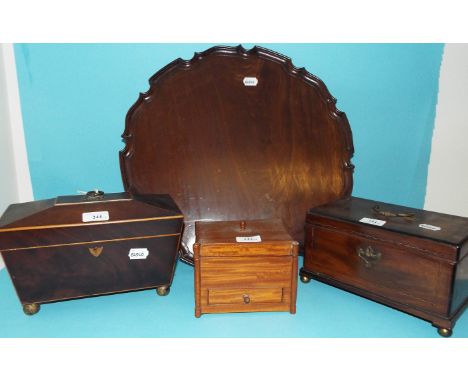 A mahogany tea caddy, with boxwood stringing, 27.5 cm wide, two other tea caddies, and a mahogany tray, with a pie crust rim,