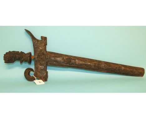 A Malayan kris, with carved hardwood handle and scabbard