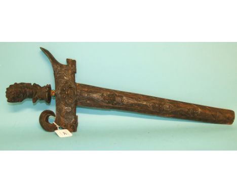 A Malayan kris, with carved hardwood handle and scabbard