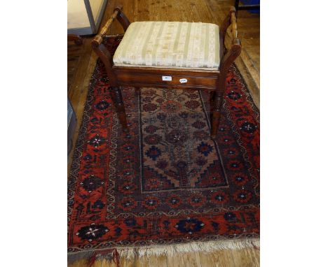 A Persian rug, decorated stylised floral motifs on a cream ground, 164 x 98 cm, and a box top piano stool (2)