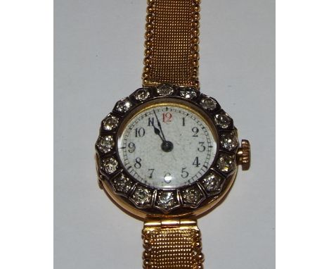 A lady's 18ct gold wristwatch, the white enamel dial with Arabic numerals within a diamond bezel, set 16 old brilliant cut st